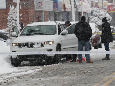 Police are inspecting the white jeep where Tyrone Jones was killed by Isaiah Stokes.